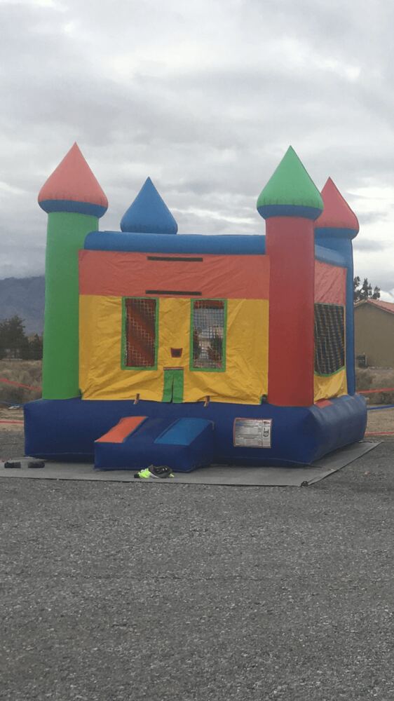 Classic castle-style bounce house in bright primary colors