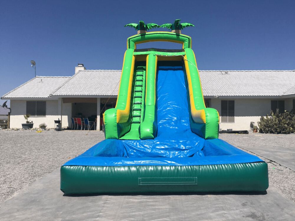 Tall green water slide with splash pool