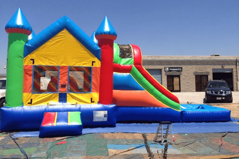 Castle combo bouncer with slide and attached splash pool